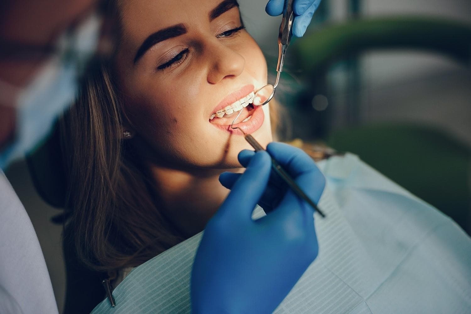 Una donna riceve un trattamento ortodontico da un dentista, con strumenti professionali in un ambien.
